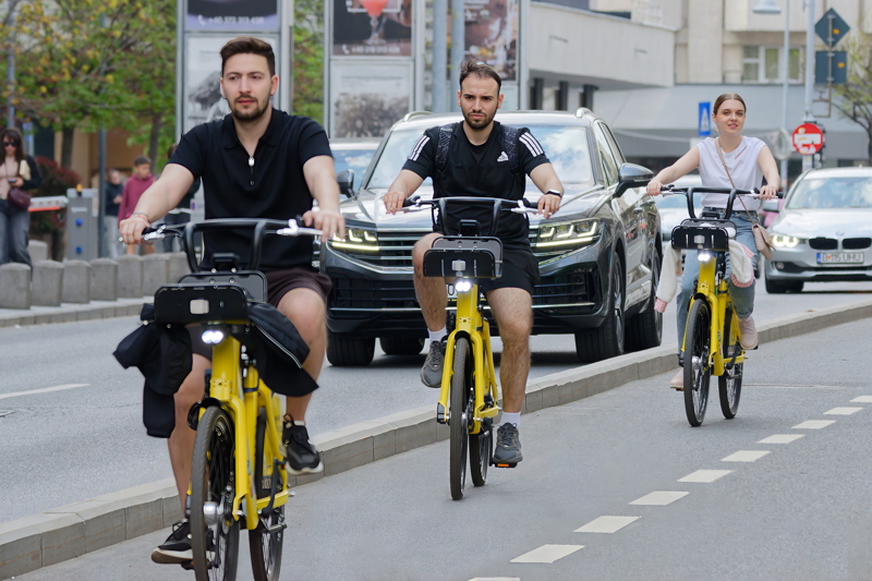 Three cyclists running on bike lane